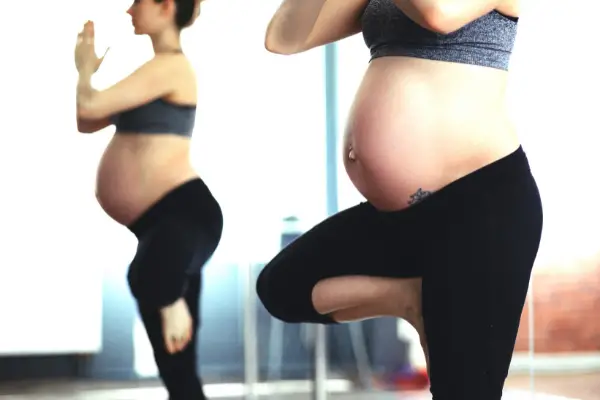 Pregnant woman doing standing position yoga