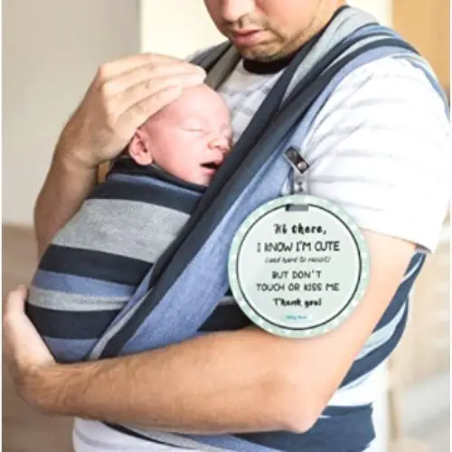An image of a father using a Don't Kiss the Baby sign for his newborn
