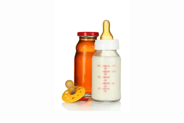 Image of an Orange juice a binky and a feeding bottle