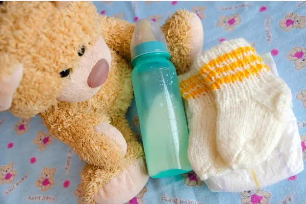 Set of baby essentials and a teddy bear