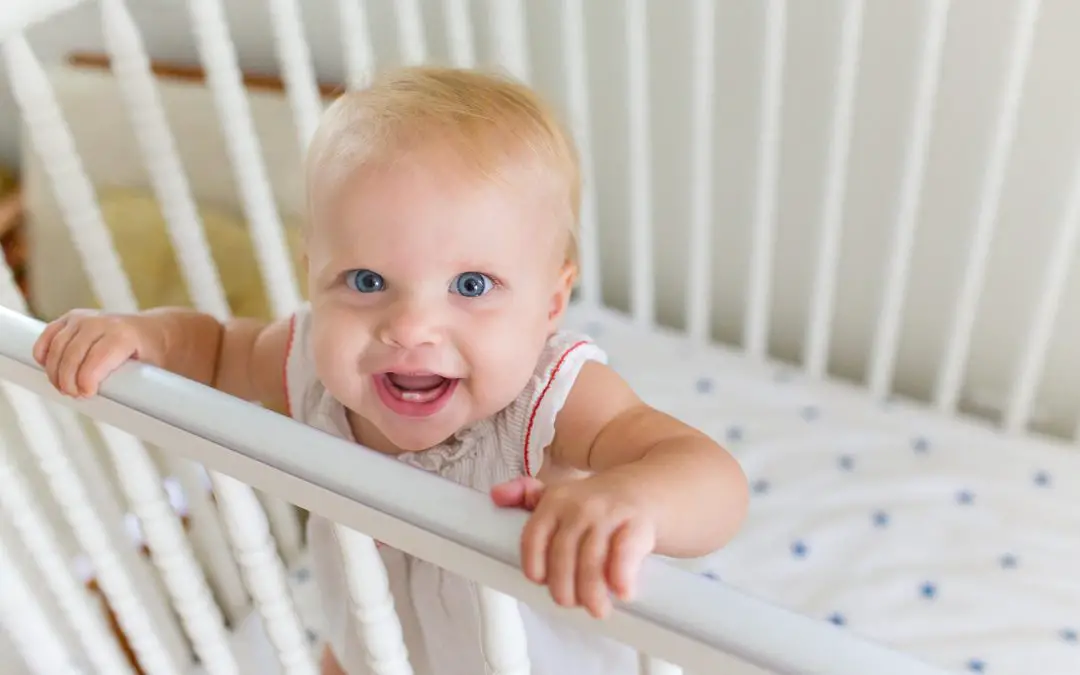 Baby girl on the crib standing