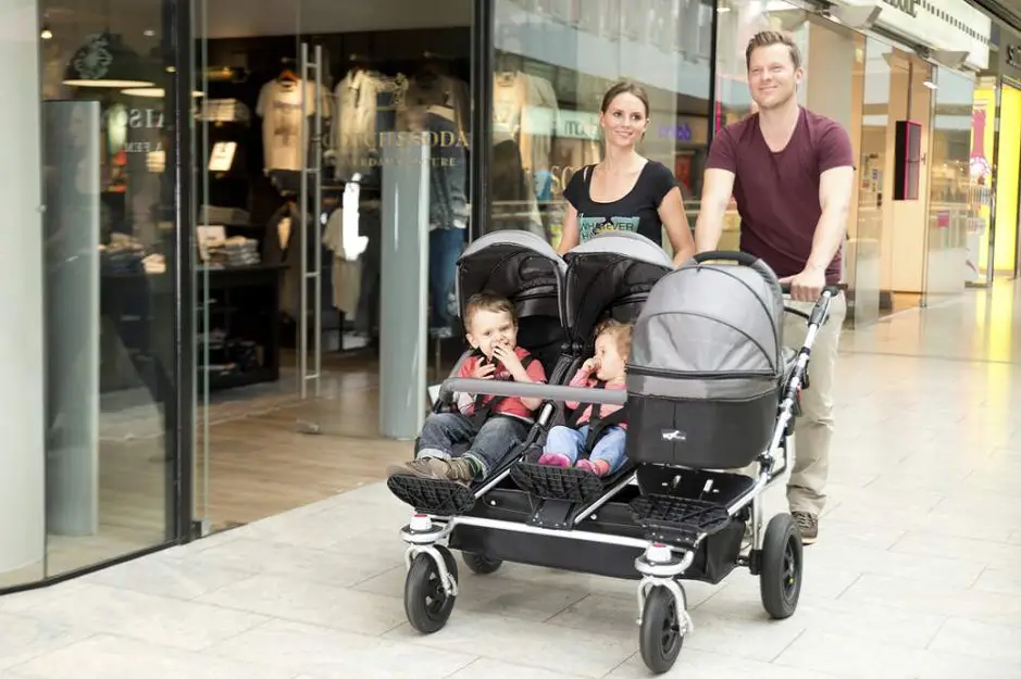 Three child family in a stroller