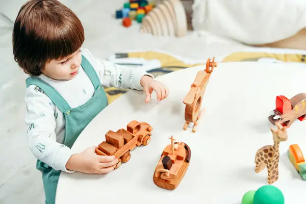 Kid playing wooden toys