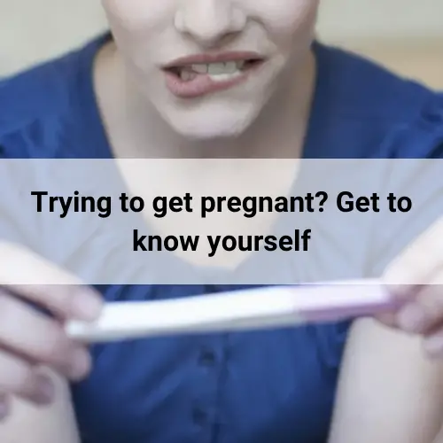 Woman biting her lip holding a pregnancy test kit