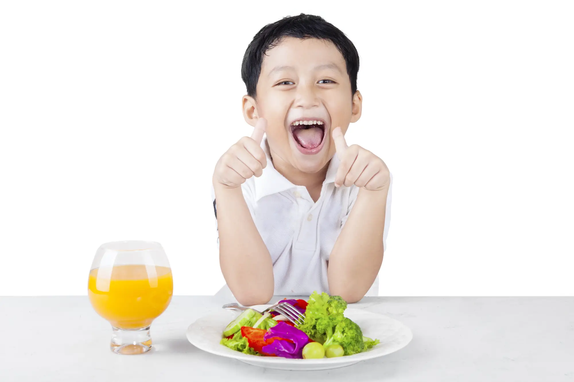 Cheerful toddler with healthy salad