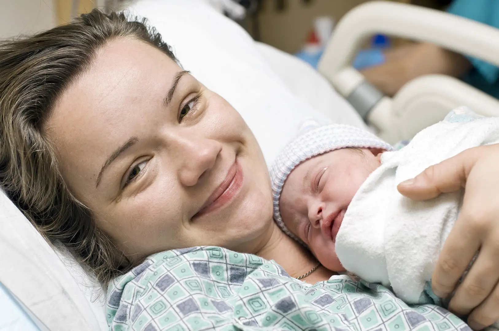 New mom hugging her baby after childbirth