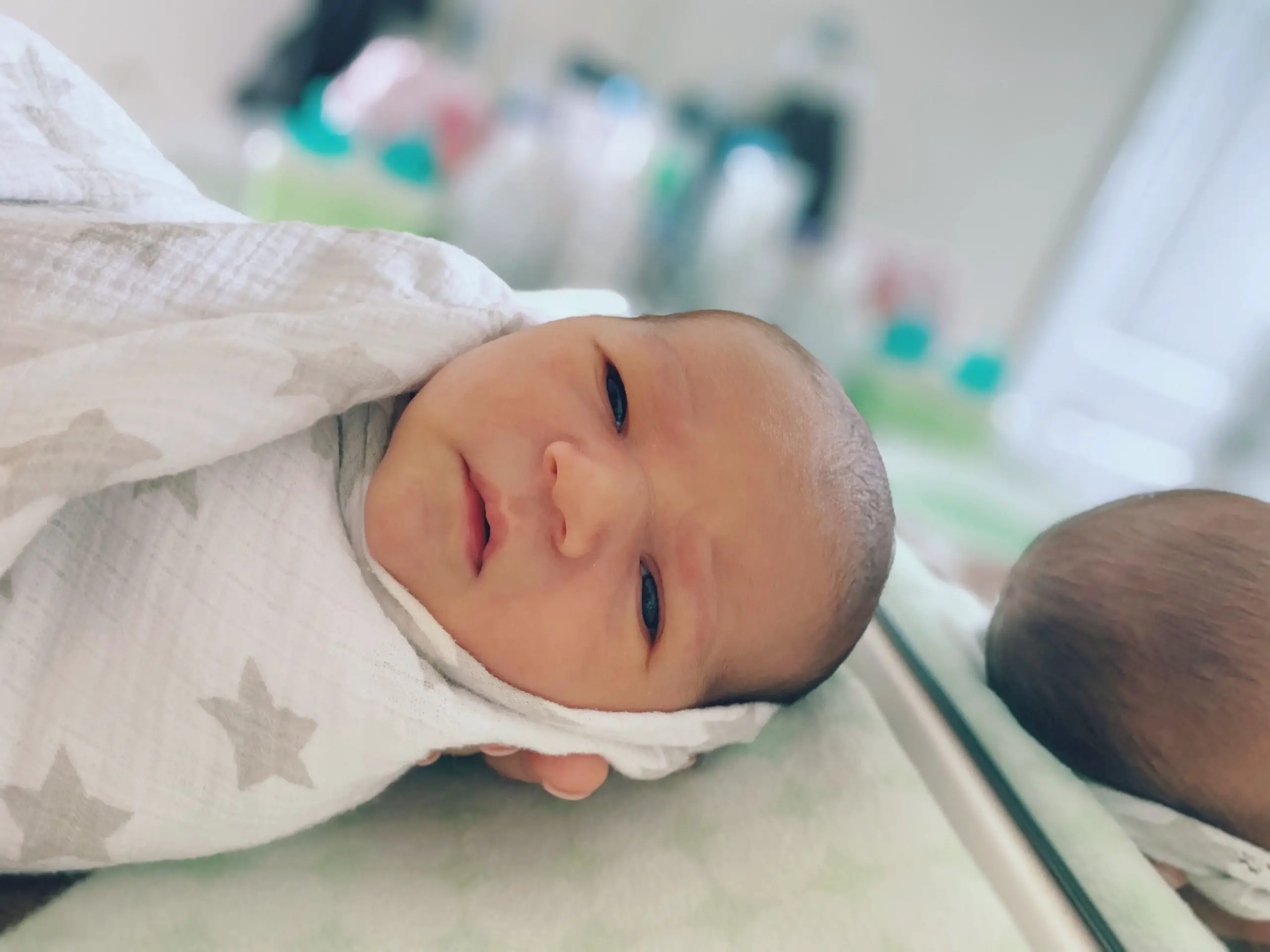 new born wrapped in star printed cloth