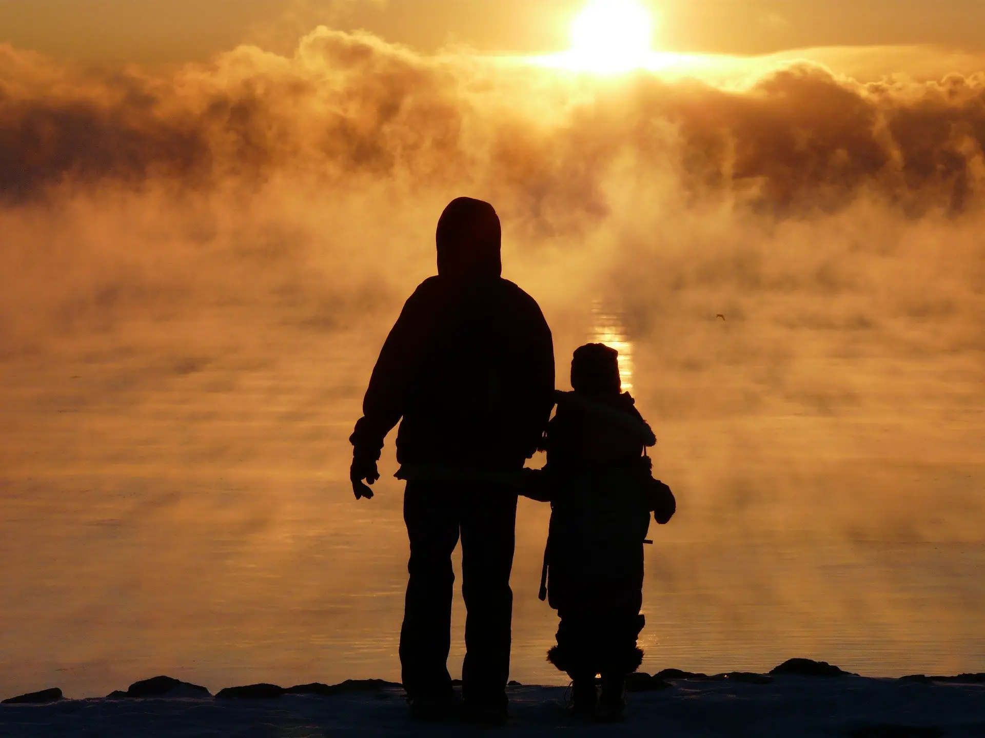 Father and child enjoying the sunrise