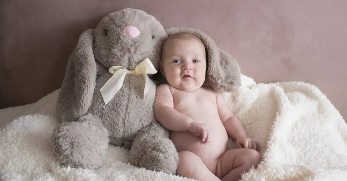 Sitting baby with big ears stuffed toy