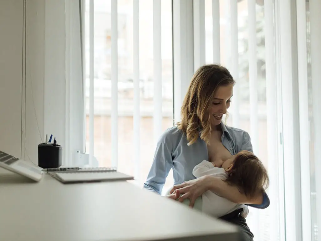 Work from home mom breastfeeding baby